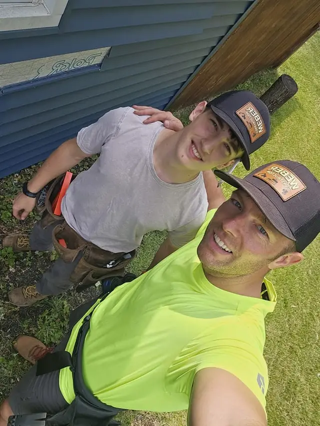 Two Weber Construction crew members in branded caps on a job site